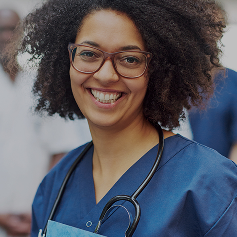 Smiling,Young,Black,Female,Doctor,Standing,In,Front,Of,Medical